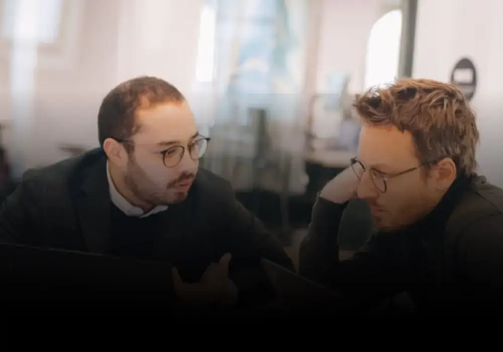 Two colleagues reviewing results on a screen